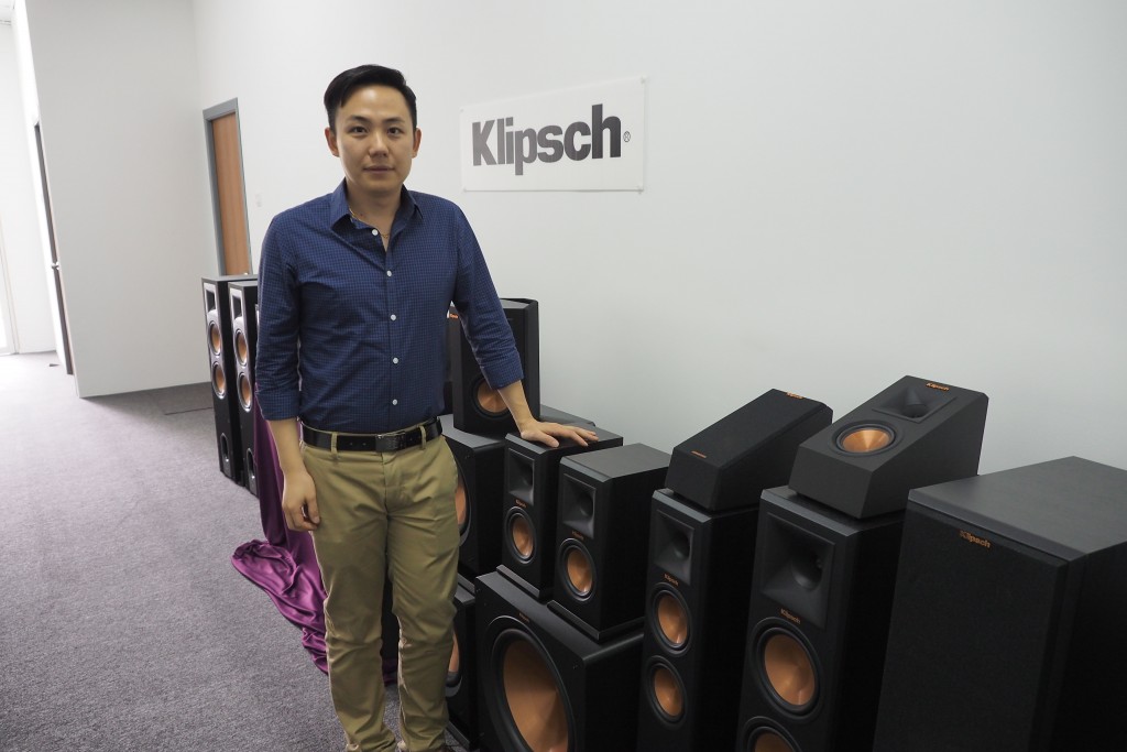 Chuck Chen from Klipsch Group Asia posing next to the Klipsch Reference Premiere range.
