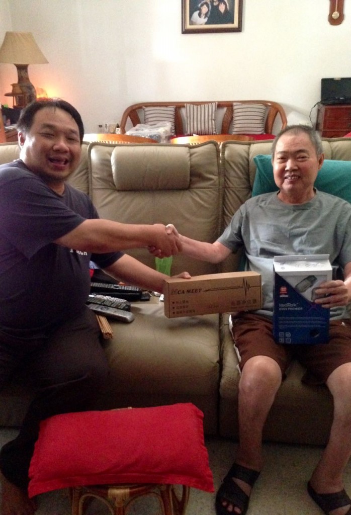 Willy Low (left) presenting the toys to Jepson Teoh.