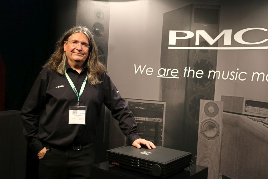 PMC owner and founder Peter Thomas posing next to the cor integrated amplifier.