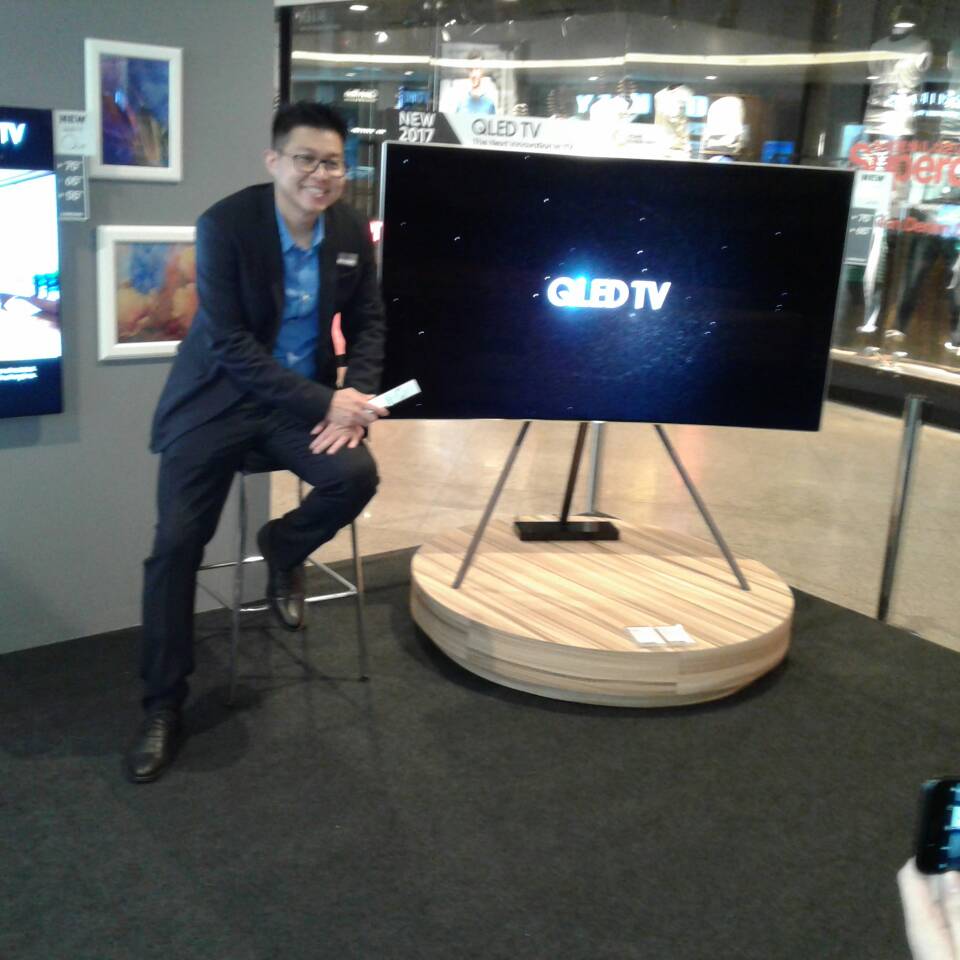 Jason Foo seen here with a QLED UHDTV on one of the options of stand available.  The one seen here is known as the STUDIO mount