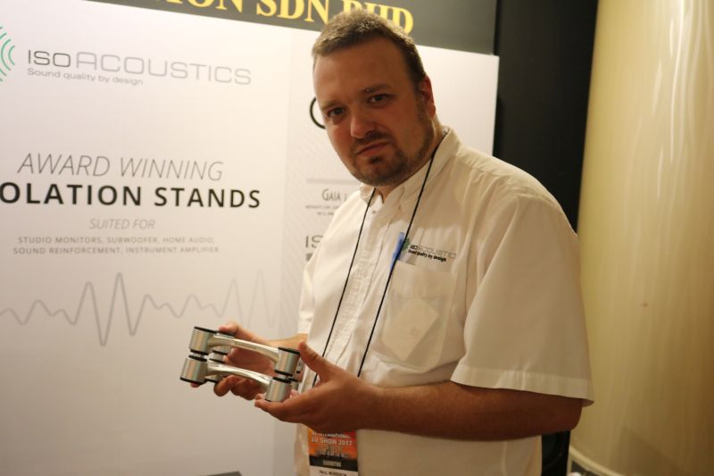 IsoAcoustics' Paul Morrison holding an IsoAcoustic isolatioon stand.