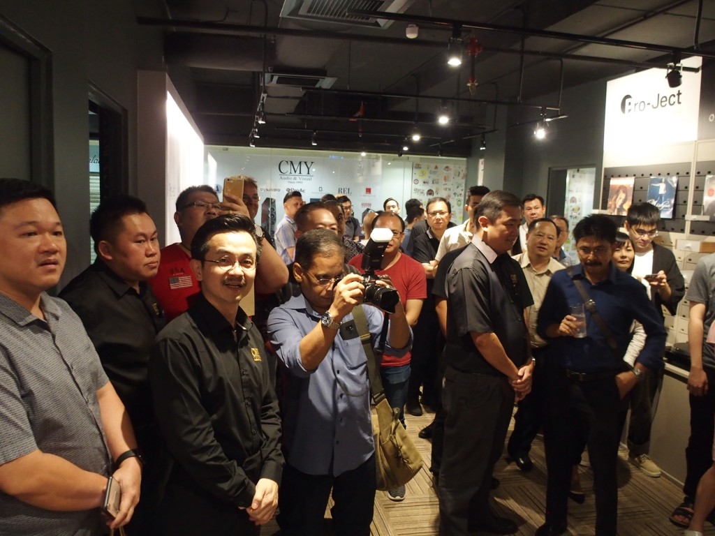 The guests listening to live music in a small hall inside the CMY showroom.