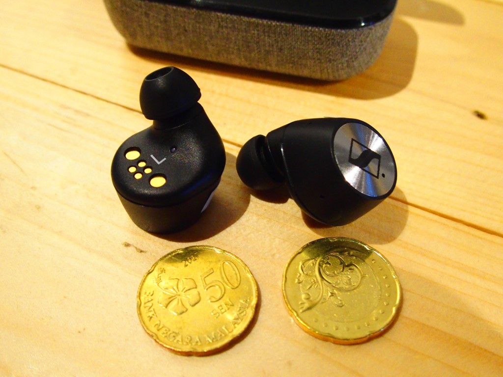 The Sennheiser True Wireless in-ear monitors. Compare them in size with the 50-sen coins.