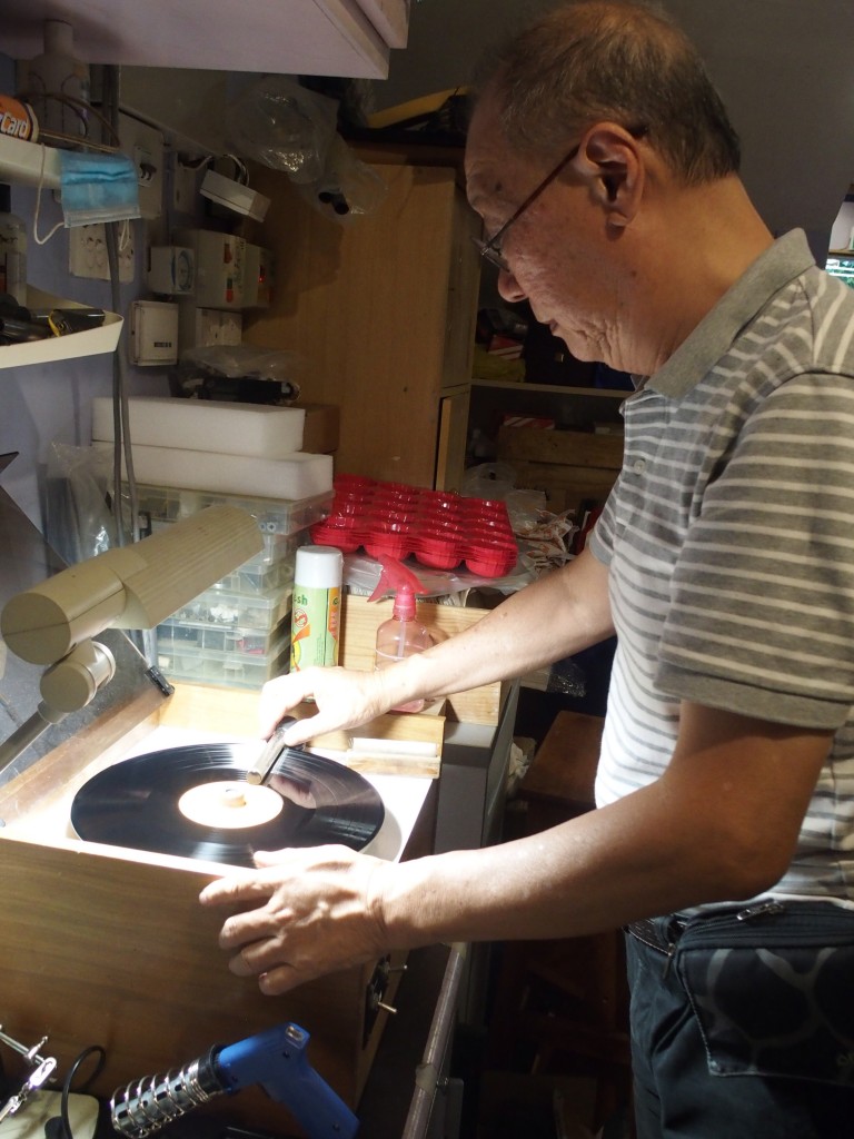 Adrian Wong cleaning the LP on the record-cleaning machine of his own design.