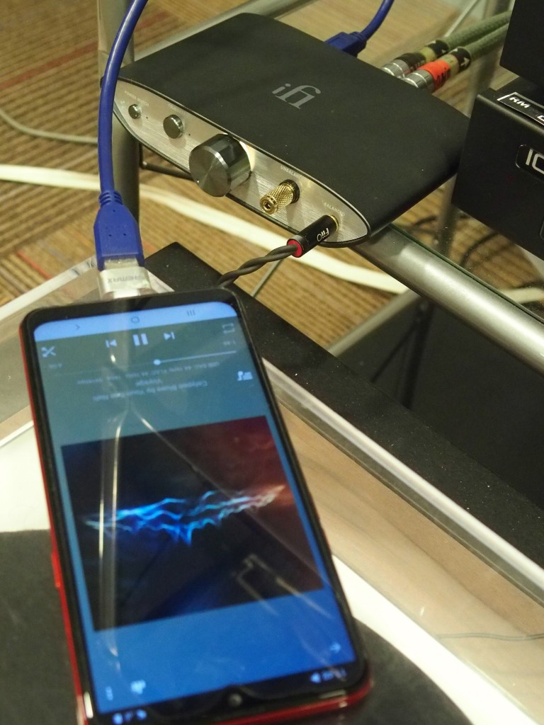The Samsung smartphone connected to the iFi ZEN DAC.