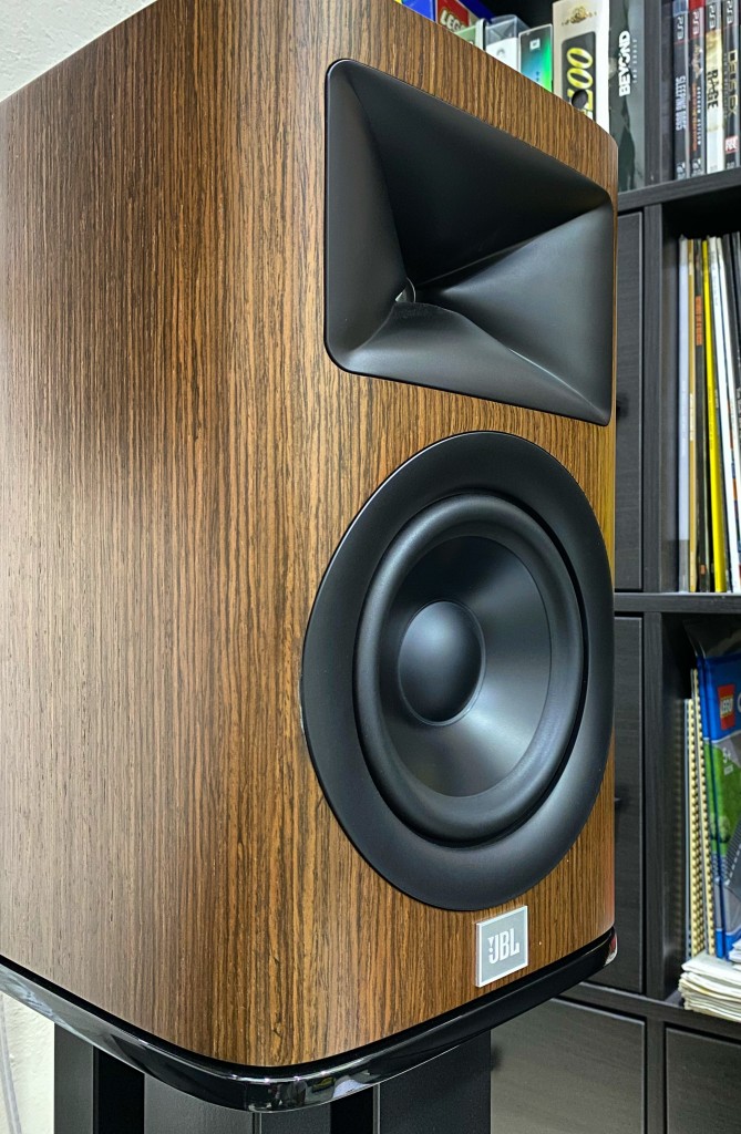  The speaker has a plinth like base that’s a high gloss black providing contrast to the walnut finish on my review unit.